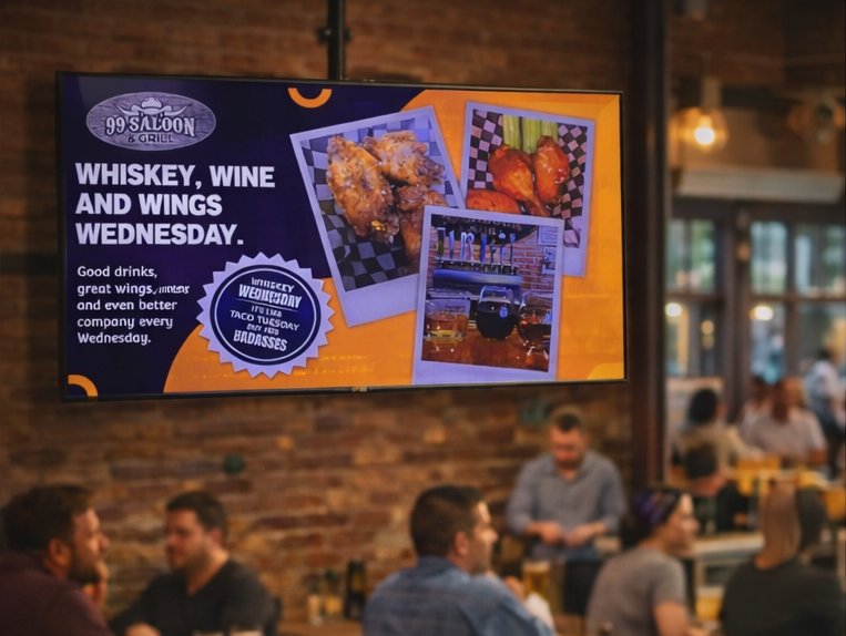 Bar with digital screen advertising wings and whiskey night